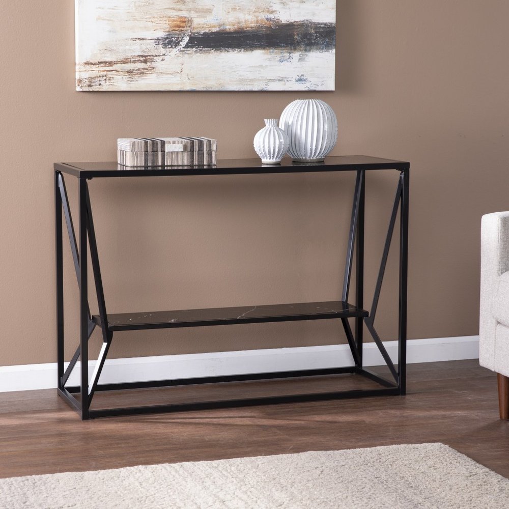 Black glass and metal console table with a lower shelf and angled X-frame sides