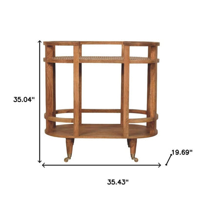 35" Golden Brown Rattan and Solid Wood Oval Wheel Console Table With Shelf