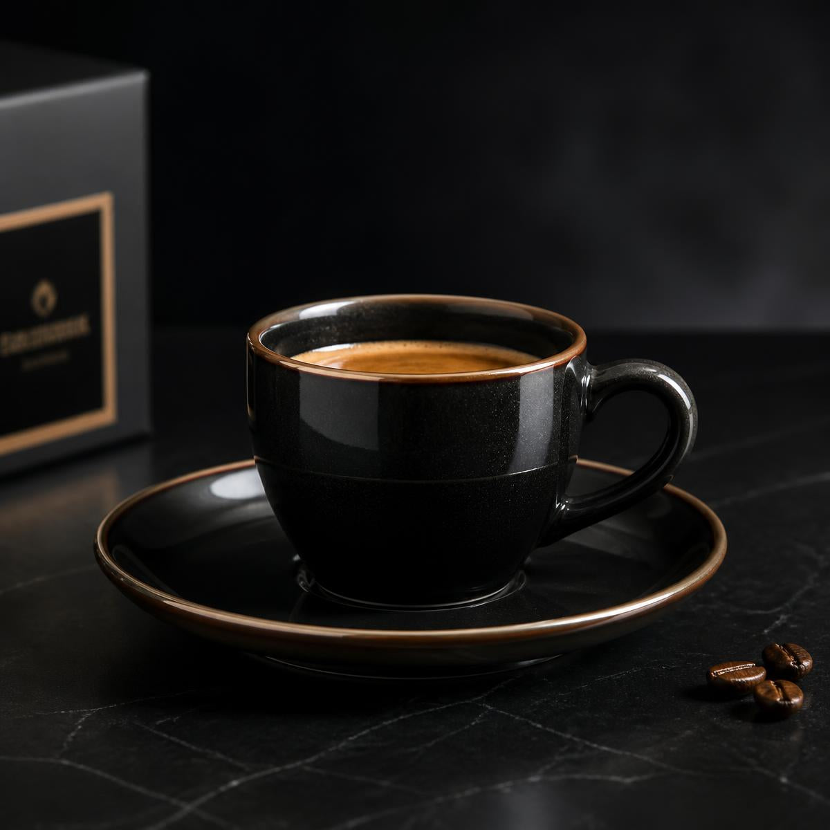 Black ceramic espresso cup and saucer with bronze rim